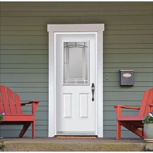  The porch features a white door and two striking red chairs, inviting relaxation and a sense of home.