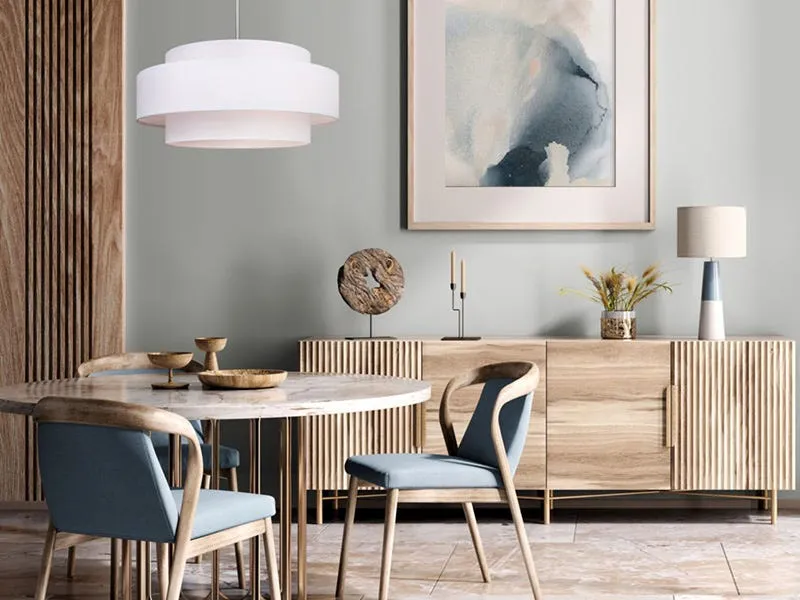 Dining room with layered white pendant ceiling light above round table