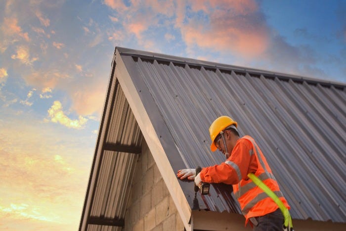 Man working on metal roof